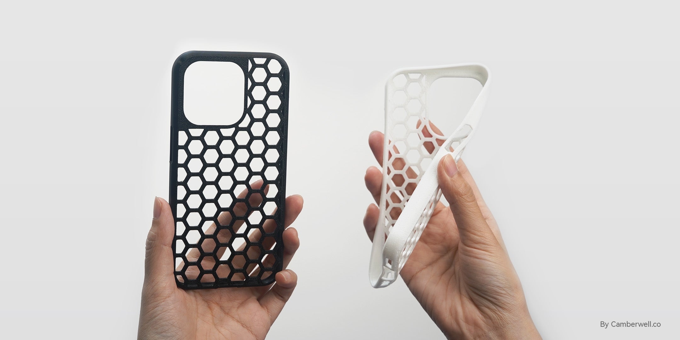 3D printed black and white honeycomb phone cases demonstrating Flashforge's rapid printing capabilities