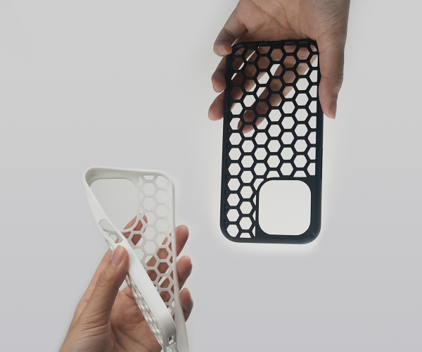 3D printed black and white honeycomb phone cases demonstrating Flashforge's rapid printing capabilities