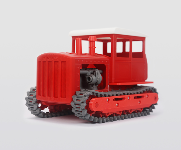 Flashforge 3D printed red tractor model showcasing rapid high-temperature printing capability